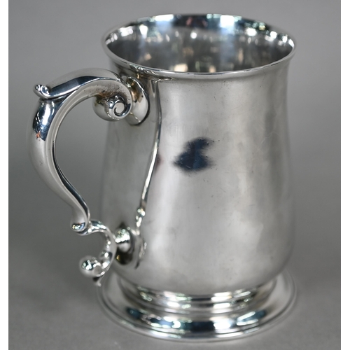 90 - A George III silver baluster pint mug with scroll handle and moulded flared foot, maker -F (rubbed),... 