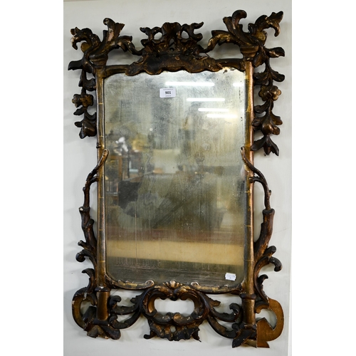 901 - A George III carved and moulded giltwood framed mirror, the plate displaying patination through age,... 