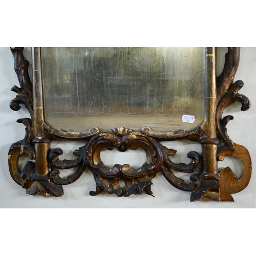 901 - A George III carved and moulded giltwood framed mirror, the plate displaying patination through age,... 