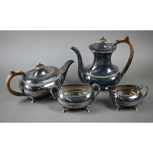 91 - A heavy quality silver four-piece tea/coffee service with simulated ivory handles and chased pad fee... 