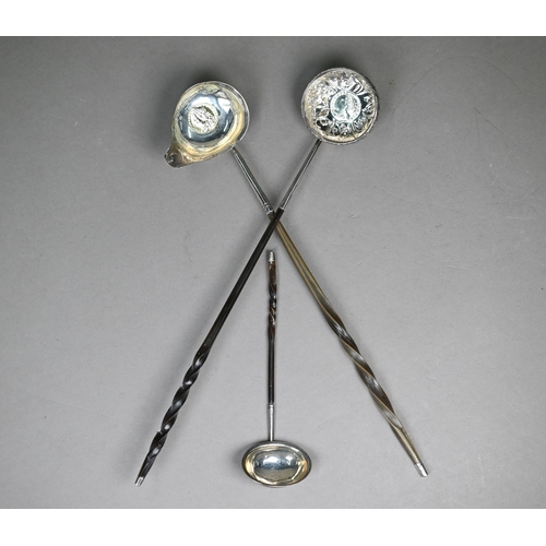 94A - A George III silver punch ladle, set with a gilt 1758 shilling, London 1788, on twisted whalebone st... 