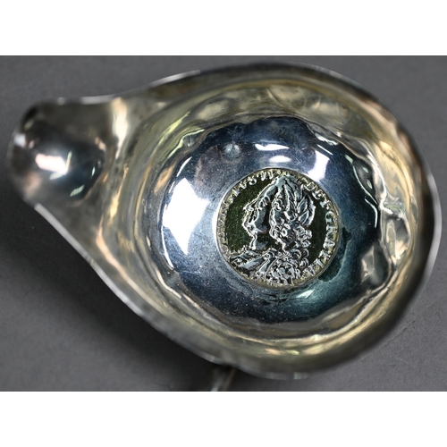 94A - A George III silver punch ladle, set with a gilt 1758 shilling, London 1788, on twisted whalebone st... 