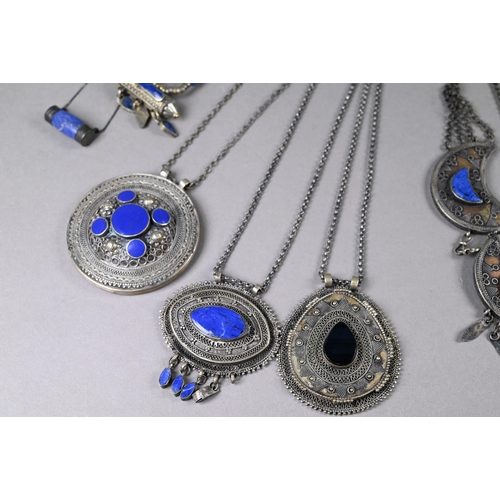 303 - A collection of various Afghan jewellery items including white metal pendants, necklaces, etc some s... 