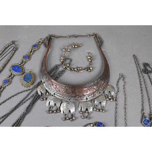 303 - A collection of various Afghan jewellery items including white metal pendants, necklaces, etc some s... 