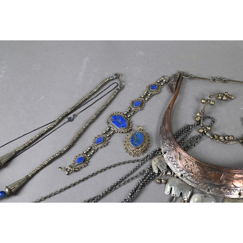 303 - A collection of various Afghan jewellery items including white metal pendants, necklaces, etc some s... 