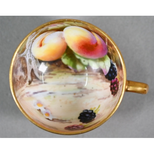 586 - A Royal Worcester miniature gilded cabinet cup and saucer painted with fruit, the 5.8 cm diameter cu... 