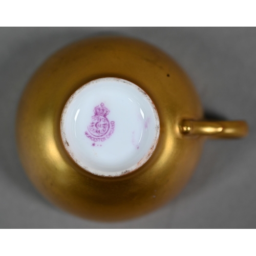 586 - A Royal Worcester miniature gilded cabinet cup and saucer painted with fruit, the 5.8 cm diameter cu... 