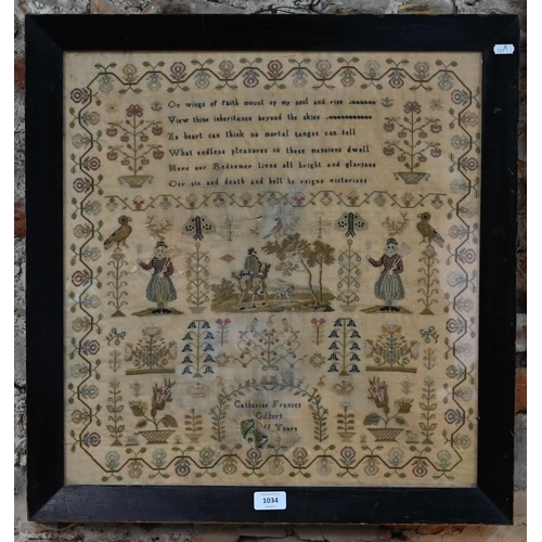 1034 - A large petit point sampler, worked with spiritual text, rider with dog and other figures, birds, fl... 