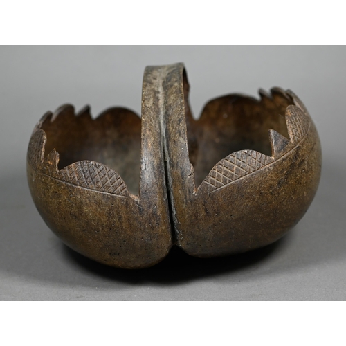 1159 - A Coco de Mer basket, containing seven polished stone eggs