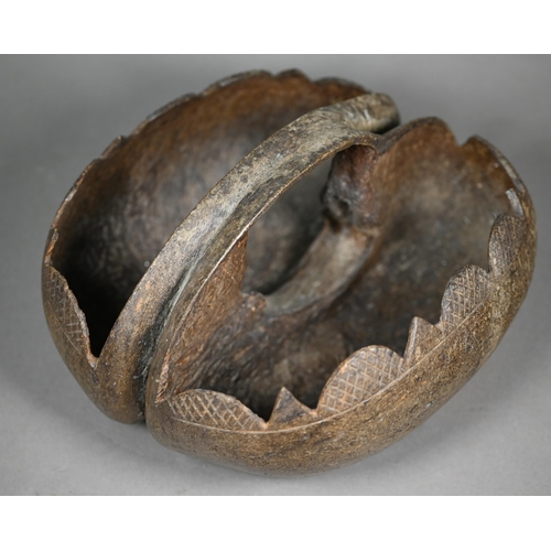 1159 - A Coco de Mer basket, containing seven polished stone eggs