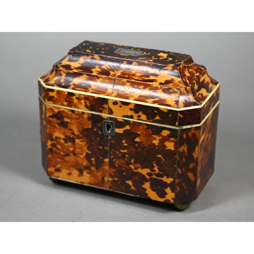 1161 - A Regency tortoiseshell sarcophagus tea caddy with moulded top enclosing two lidded compartments, on... 