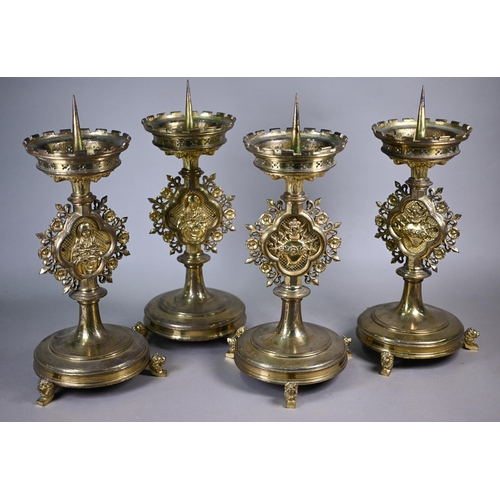 1162 - A set of four 19th century Gothic Revival brass 'Sacré Coeur' candlesticks attributed to Hardman &am... 