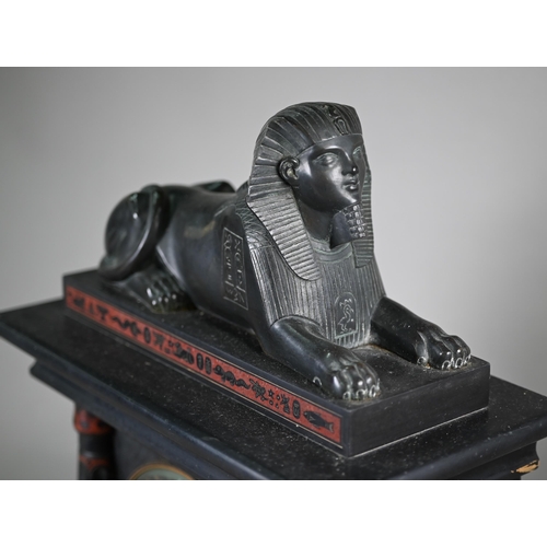 795 - A Victorian Egyptian Revival slate mantel clock, surmounted by a bronzed sphinx, the black dial with... 