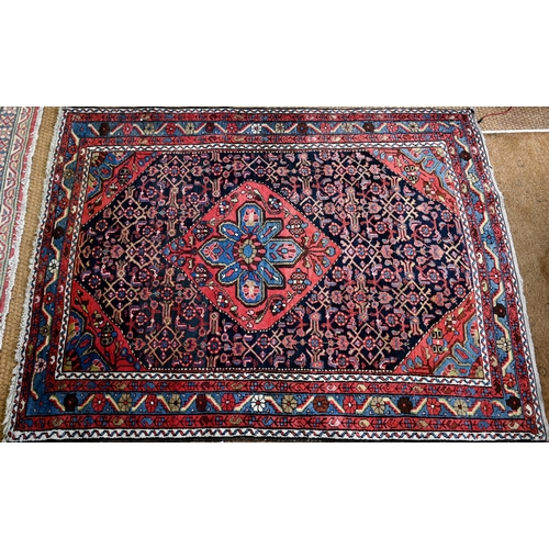 801 - An old Persian Hamadan rug, the blue ground centered by a red ground medallion, 92 cm x 142 cm