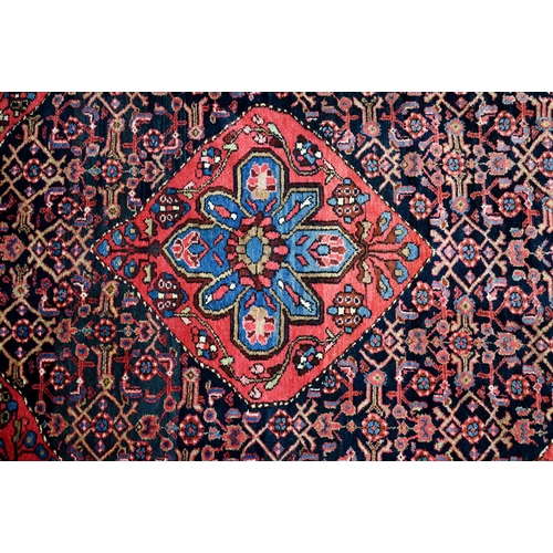 801 - An old Persian Hamadan rug, the blue ground centered by a red ground medallion, 92 cm x 142 cm