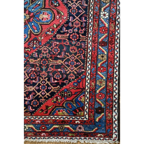 801 - An old Persian Hamadan rug, the blue ground centered by a red ground medallion, 92 cm x 142 cm