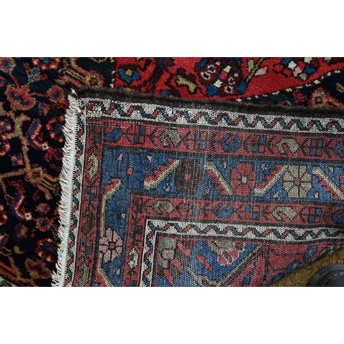 801 - An old Persian Hamadan rug, the blue ground centered by a red ground medallion, 92 cm x 142 cm