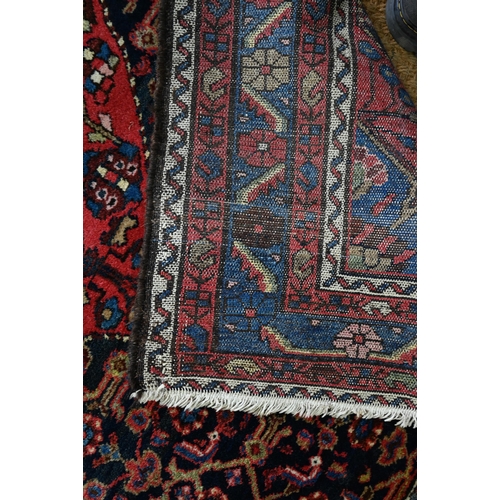 801 - An old Persian Hamadan rug, the blue ground centered by a red ground medallion, 92 cm x 142 cm