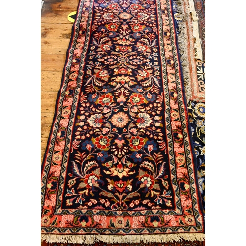 805 - A Persian Hamadan runner, the repeating stylised design on blue ground, 380 cm x 83 cm