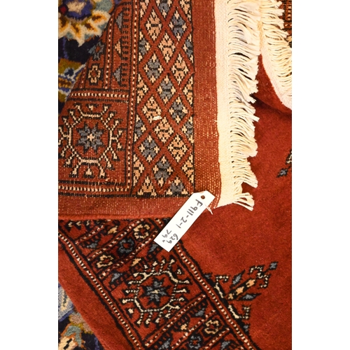 806 - A Bokhara long red ground runner of repeating designs, 629 x 79 cm