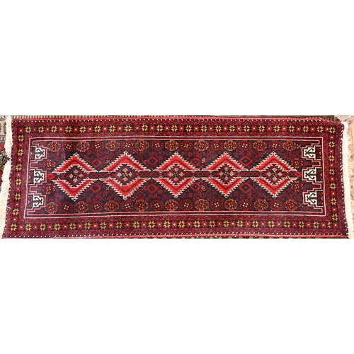 809 - A contemporary Persian Meshad Baluchi design runner, the diamond pole design on navy ground, 200 cm ... 