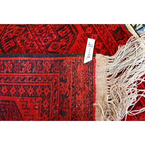 812 - An Afghan red ground runner with two rows of guls, 320 cm x 91 cm