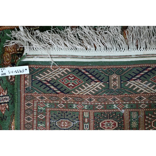 818 - Indian green ground rug, 200 x 123 cm