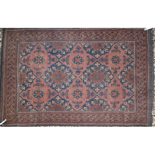 819 - An old brown ground Baluch rug, 188 cm x 128 cm