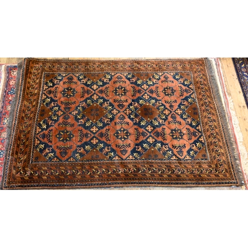 819 - An old brown ground Baluch rug, 188 cm x 128 cm