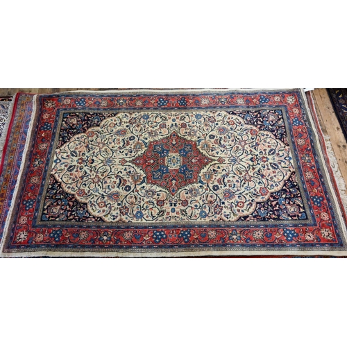 820 - An old North West Persian Sarouk rug, the camel ground with floral garden design, 217 cm x 133 cm