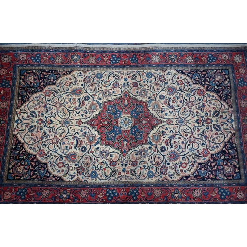 820 - An old North West Persian Sarouk rug, the camel ground with floral garden design, 217 cm x 133 cm