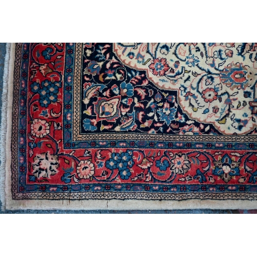 820 - An old North West Persian Sarouk rug, the camel ground with floral garden design, 217 cm x 133 cm