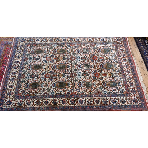 821 - An antique Persian Kashan rug, the repeating design of floral vines on camel ground, 208 cm x 138 cm