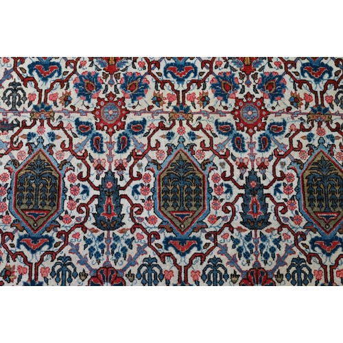 821 - An antique Persian Kashan rug, the repeating design of floral vines on camel ground, 208 cm x 138 cm