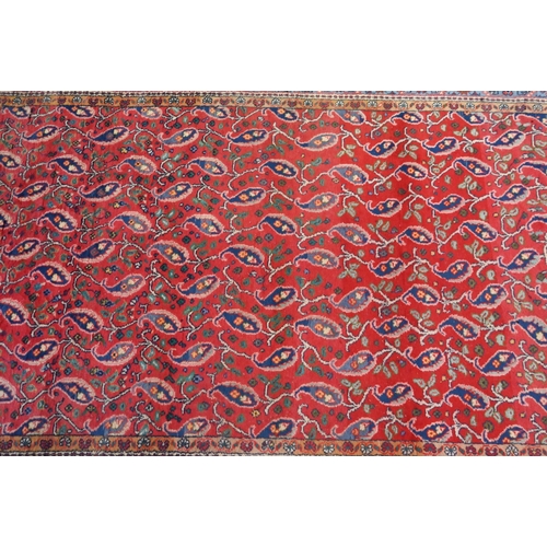 822 - A mid-century Persian Hamadan rug, the stylised floral design on mid-red ground, 240 cm x 150 cm