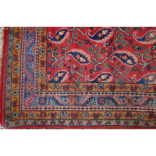 822 - A mid-century Persian Hamadan rug, the stylised floral design on mid-red ground, 240 cm x 150 cm