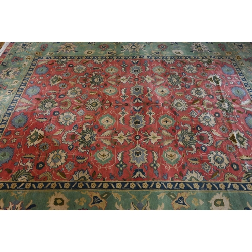 825 - An old Indian Agra carpet, predominantly pale green and pink, 352 cm x 278 cm