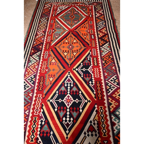 829 - A contemporary South West Persian Qashqai Kelim with repeating stylized lozenges in multi-colours, 2... 