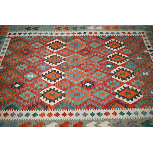 831 - A contemporary Anatolian kelim, the geometric design executed in multi-colours, 297 cm x 208 cm