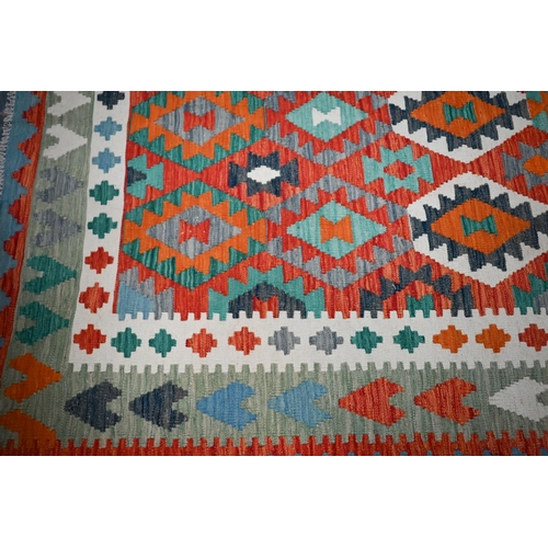 831 - A contemporary Anatolian kelim, the geometric design executed in multi-colours, 297 cm x 208 cm