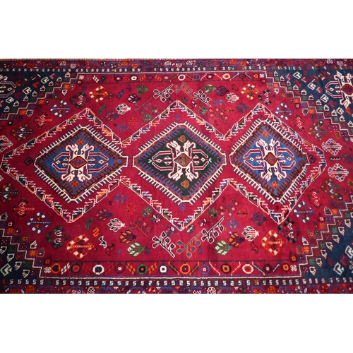 837 - A South West Persian Qashqai carpet, the triple pole design on red ground, 260 cm x 165 cm