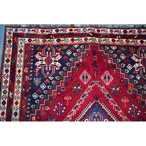 837 - A South West Persian Qashqai carpet, the triple pole design on red ground, 260 cm x 165 cm