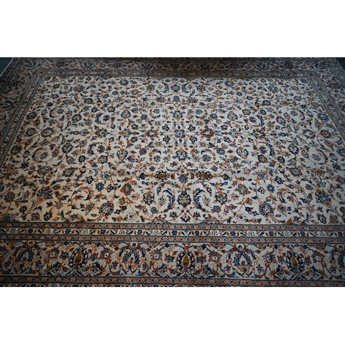 838 - A central Persian Kashan carpet, the overall floral vine design on camel ground, 400 cm x 290 cm