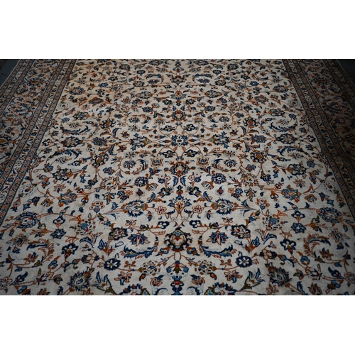 838 - A central Persian Kashan carpet, the overall floral vine design on camel ground, 400 cm x 290 cm