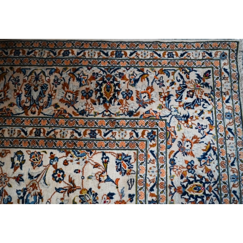 838 - A central Persian Kashan carpet, the overall floral vine design on camel ground, 400 cm x 290 cm