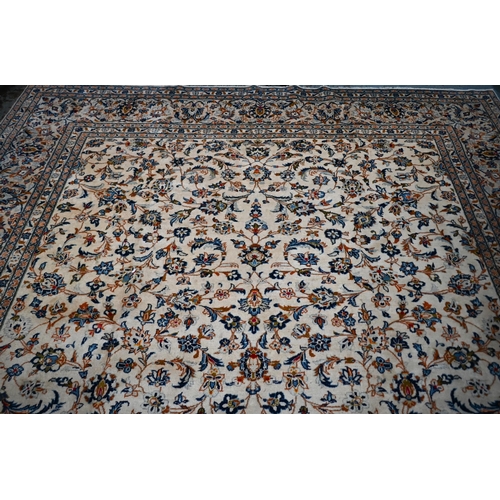 838 - A central Persian Kashan carpet, the overall floral vine design on camel ground, 400 cm x 290 cm