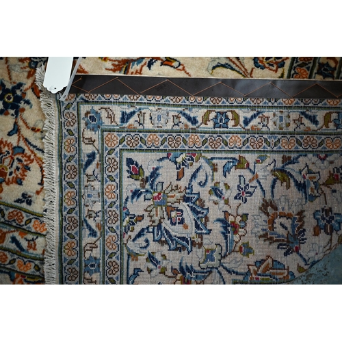 838 - A central Persian Kashan carpet, the overall floral vine design on camel ground, 400 cm x 290 cm