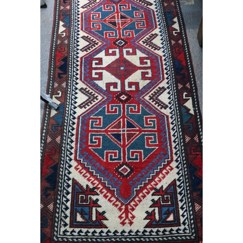 841 - A Continental Turkish runner, the camel ground with geometric pole design, 323 x 71 cm