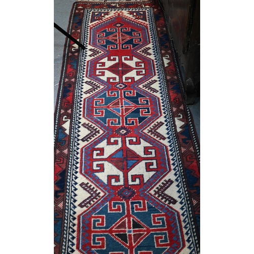 841 - A Continental Turkish runner, the camel ground with geometric pole design, 323 x 71 cm