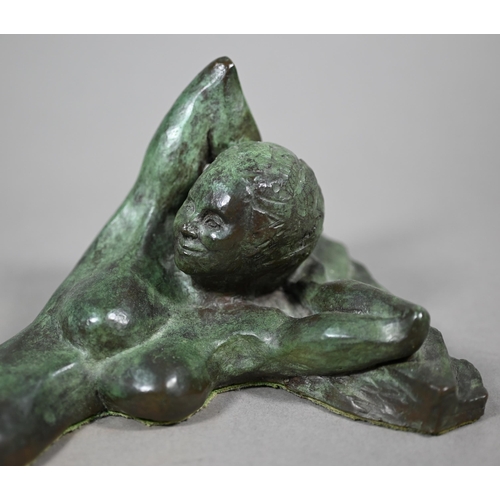 856 - Charlotte Jackson - A verdigris patinated bronze sculpture of a reclining woman, 42 cm long